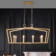 a chandelier hanging from the ceiling in a room with black walls and furniture