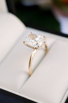 an engagement ring in a box on display