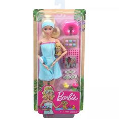 the barbie doll is wearing a blue towel and holding a teddy bear in her hand