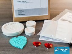 some crafting supplies are laying out on a wooden table with the package in front