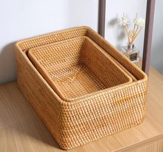 a wicker basket sitting on top of a wooden table