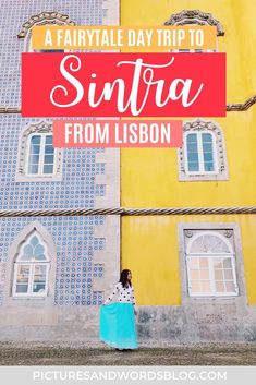 a woman standing in front of a yellow and blue building