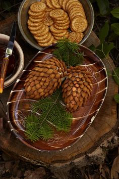 some pine cones are sitting on a plate next to other foods and condiments