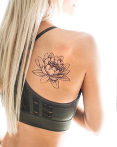 a woman with a flower tattoo on her back