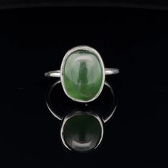 * Sterling Silver ring with Nephrite Jade  * The face of this ring measures 14mm X 13mm * This ring is size 7 * You will receive the exact ring pictured. Classic Green Opal Cabochon Ring, Green Oval Opal Ring With Polished Finish, Modern Green Oval Cabochon Jewelry, Modern Sterling Silver Green Rings, Green Oval Cabochon Signet Ring As Gift, Green Oval Cabochon Signet Ring For Gift, Modern Green Sterling Silver Rings, Adjustable Green Oval Opal Ring, Jade Oval Cabochon Rings With Polished Finish