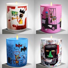 four different colored candles with designs on them