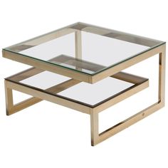 a glass and metal coffee table sitting on top of a white floor