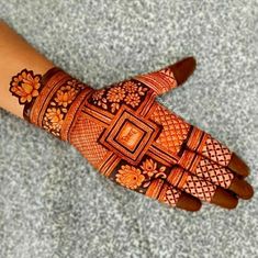 a woman's hand with hennap and flowers on the palm, showing her intricate