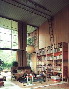 a living room filled with lots of books and furniture