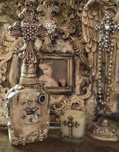 an ornate photo frame with candles and other items