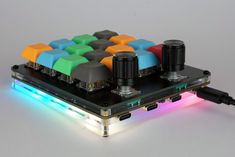 a multicolored electronic device with multiple lights on it's back end and sides