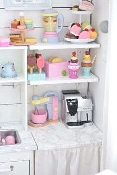 a kitchen with shelves filled with cakes and cupcakes