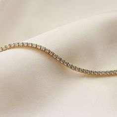 Dainty CZ Diamond Tennis Bracelet - Featuring a beautiful CZ Diamond Tennis Bracelet, dainty and great for everyday wear - Lengths: 6.5" + 1" Extender - Measurement: CZ Diamond - 1.5mm - Base Material: High Quality 925 Sterling Silver - Finish: 18K Gold - Nickel Free - All our jewelry is packaged in gift ready boxes. If you would like multiple items from your order packaged separately please let us know! © 2023 Generation of Daughters Gold Tennis Bracelet, Bracelet Tennis, Cz Bracelet, Bracelet Minimalist, Bracelet Simple, Diamond Tennis Bracelet, Bracelet Dainty, Wedding Jewelry Bracelets, Minimalist Bracelet