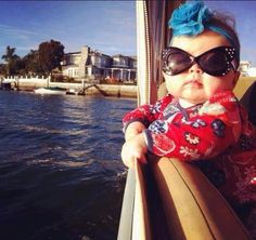 a baby wearing sunglasses with the caption, one's confidence defined by her capacity