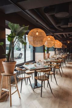 an empty restaurant with wooden tables and chairs