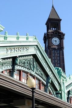 a clock tower is in the background behind a building with an ornate roof and steeple