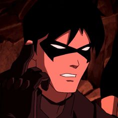 an animated image of a man with black hair wearing a batman mask and talking on a cell phone