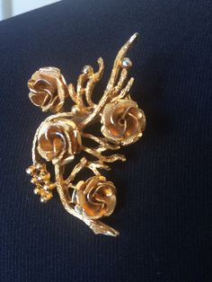 Beautiful vintage Coro brooch in gold tone and rose bouquet design. Signed Coro. Measures about 2 1/8 inches by 1 ¼ inches. In very good vintage condition. Please see this section of my shop for more vintage costume jewelry: https://www.etsy.com/shop/ChrisandTine?section_id=17309162 My full shop: http://www.chrisandtine.etsy.com Prices are listed for Canada and USA only but if you wish to have them shipped elsewhere, please message me the shipping address and I will gladly send you a quote. We p Vintage Rose Gold Brooches For Wedding, Vintage Rose Gold Wedding Brooches, Vintage Gold Flower Brooch, Vintage Gold Flower Brooches, Formal Gold Brooch With Rose Design, Bouquet Brooch, Brooch Bouquets, Bouquet Design, Vintage Costume Jewelry