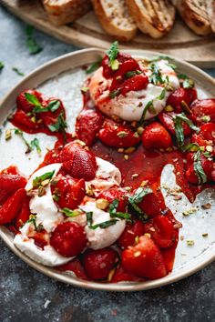 strawberries and whipped cream on a plate with bread