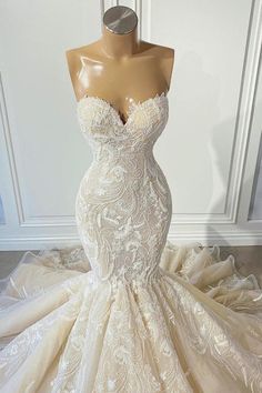 a wedding dress on display in front of a mannequin