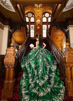 a woman in a green dress standing on stairs