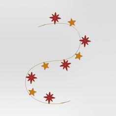 the letter s made out of red and yellow stars is hanging from a gold wire