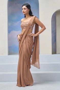 Brown pre-draped saree. Paired with a blouse with all over moon and star embroidery. - Aza Fashions Elegant Draped Skirt For Festive Occasions, Party Wear Dupatta For Diwali, Draped Style, Pre-draped Wedding Sets, Festive Draped Dupatta, Traditional Draped Wedding Skirt, Festive Pre-draped Skirt For Weddings, Festive Pre-draped Wedding Skirt, Designer Wear Pre-draped Saree With Draped Sleeves, Draped Georgette Lehenga