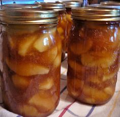 three jars filled with food sitting on top of a table