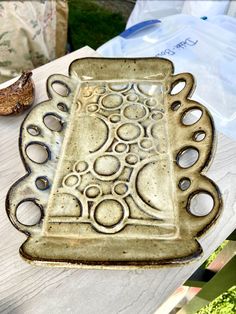 a ceramic dish sitting on top of a wooden table