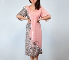 "Vintage 1980s fully sequined silk dress in pink and silver with an intricate bead and sequin design along the right side - You're sure to steal the scene! ✈ Measurements ✈ * Taken from SEAM to SEAM with garment lying flat *  Shoulder to Shoulder * 18\" Bust * 19.5\" Sleeve * 9.25\" Waist * 19\" Hips * 20\" Length * 45\" ✈ Specifics ✈ Label: Las Palmas, made by Papillon (made in India) Tagged Size: L Approx. Fit: Medium Color: Pink, Silver Material: 100% Pure Silk, Sequin, Beads Condition: A few missing sequins and beading throughout, overall in Good Vintage Condition ✈ Features ✈ * V neckline * Shoulder pads * Short peaked sleeves * Lower side slits * Fully embellished base (intricate bead and sequin design) - No zippers or fastenings, this goes on (and comes off) over your head . . . . . Pink Embellished Sequin Fabric For Cocktail, Pink Sequin Fabric For Spring Cocktail, Pink Sequin Fabric For Evening, Festive Pink Dress With Contrast Sequin, Festive Pink Dresses With Contrast Sequin, Festive Pink Contrast Sequin Dress, Pink Sequin Spring Dress For Festive Occasions, Pink Sequin Dress For Spring Festive Occasions, Pink Sequin Dress For Festive Occasions