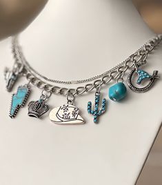 This Country Queen Charm Necklace features faux turquoise & sterling silver charms on a 18 inch curb chain w a toggle closing. Show off the cowgirl hat, cactus, horseshoe, bull, lightning bolt & a crown for all the Country Queens. It has a petite double layer above the charms that sets it apart from the others✨ Charm Jewelry Care: Since sterling silver and gold plated are a lower grade metal, it can tarnish if exposed to harsh chemicals (chlorine, cleaning supplies, etc.), strong soaps, lotions, Nickel Free Western Style Necklaces, Nickel-free Western Style Necklaces, Southwestern Blue Jewelry For Western-themed Events, Western Style Nickel Free Necklaces, Western Metal Jewelry For Western-themed Events, Western Blue Jewelry For Western-themed Events, Turquoise Necklace For Western-themed Events, Southwestern Jewelry With Adjustable Chain, Southwestern Style Jewelry With Adjustable Chain