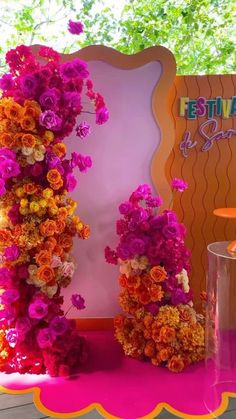 there are many flowers on the table and in front of this sign that says fiesta