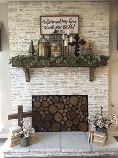 the fireplace is decorated with logs and greenery on it's mantels