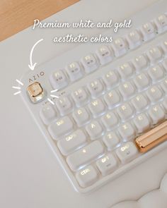 a close up of a keyboard on a table with the words, premium white and gold aesthetic colors