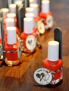 red nail polish sitting on top of a wooden table