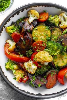 a white bowl filled with vegetables on top of a table