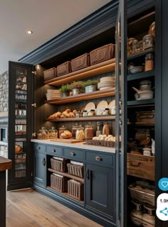 a kitchen with blue cabinets and shelves filled with breads, pastries and other items