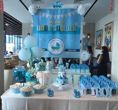 a baby shower party with blue and white decorations