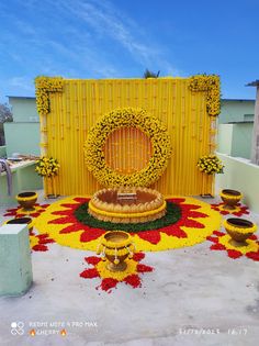 a yellow and red flower arrangement on top of a building