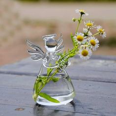 a glass vase filled with water and flowers