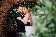 a bride and groom pose for a wedding photo