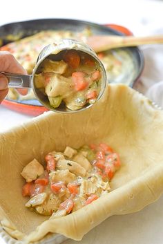 a person scooping food out of a pie pan