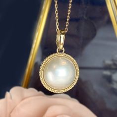 One piece of Bold Statement piece, Large Genuine White Mabe Pearl Enhancer Pendant * Center stone: Genuine White Mabe Pearl, 15-16mm in size * Pendant size: 29mm x 19.5mm including bail. Bail size approx. 4mm * Metal: 14K yellow gold * Stamp: 14k * Chain is not included, can be purchased in our shop. ❤️Follow us on Instagram @ elekalonjewelry for latest projects and designs. *If you have any questions, please feel free to message us. Exquisite Hallmarked Necklace, Luxury Round Custom Necklace For Formal Occasions, Luxury Round Cabochon Necklace, Formal Round Cabochon Necklaces, Luxury Formal Custom Round Necklace, Formal Cabochon Pendant Necklace, Luxury High Luster Mother Of Pearl Jewelry, Luxury Hallmarked Round Custom Necklace, Luxury Custom Hallmarked Round Necklace