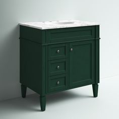 a bathroom vanity with a white marble top and dark green cabinetry, against a gray wall