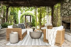 an outdoor living room with wicker furniture