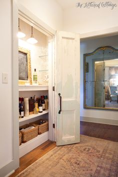 an open door leading into a room with shelves