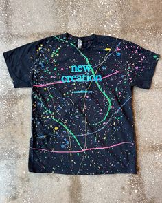 Spruce up your wardrobe with this stylish and meaningful New Creation (Splatter) Adult Box T-Shirt! This christian apparel features bold words of encouragement for you to remind yourself who you are, and the boxy design offers a clean look that spruces up any outfit. Wear it proud and be a walking, talking representation of the new creation you are! Black Cotton T-shirt With Paint Splatter, Relaxed Fit Paint Splatter T-shirt With Crew Neck, Graphic Tee With Paint Splatter For Streetwear, Streetwear Paint Splatter Graphic Tee, Graphic Tee With Paint Splatter, Streetwear Cotton Tops With Paint Splatter, Black Paint Splatter Crew Neck Top, Cotton Paint Splatter Tops For Streetwear, Casual Black Top With Paint Splatter