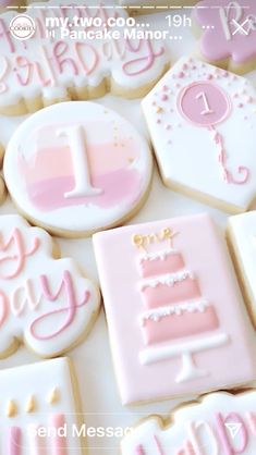 decorated cookies in the shape of baby's first birthday cake and nameplates