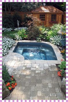 an outdoor hot tub surrounded by flowers and trees