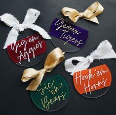 four glass ornaments with ribbons tied around them on a black surface, one has the words hope, hope, hope, hope and hope